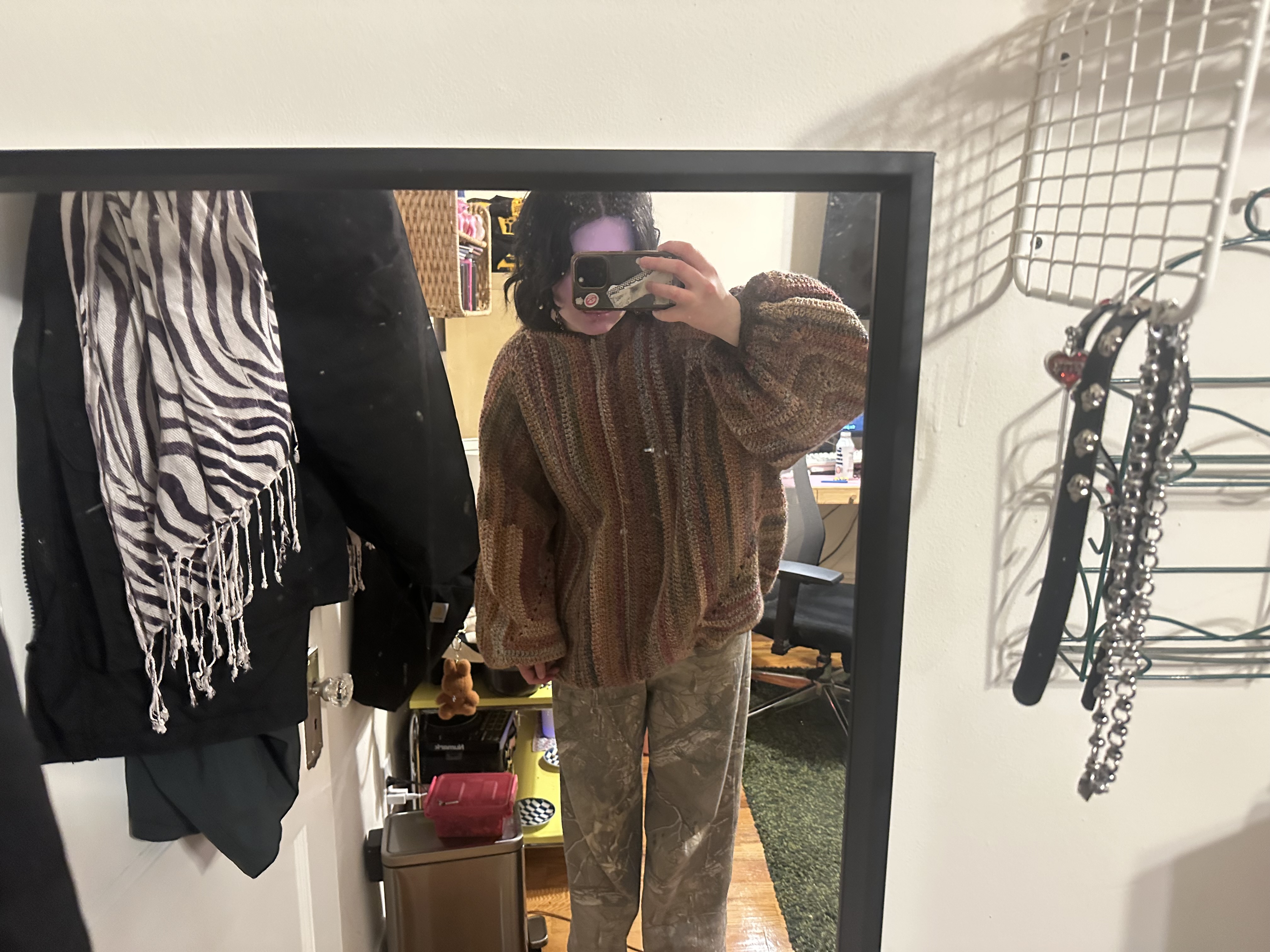 a mirror selfie in which i am bending down to get the full sweater in picture